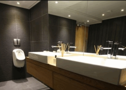 Modern office bathroom design with sleek vanities, elegant lighting, and stylish finishes that impress clients and staff.